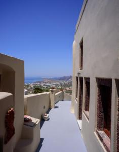 a view from the balcony of a white building at Diva Santorini Luxury Villa in Pyrgos