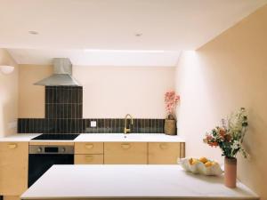 a kitchen with a sink and a counter top at Luxury bolthole in central St.Agnes with parking. in St. Agnes