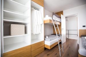 a small bedroom with a bunk bed and a closet at Villa Kraljica in Portorož +19 photos