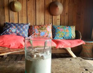 a vase sitting on a table with a couch at Lipe BeachHouse in Ko Lipe