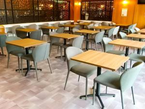 a row of tables and chairs in a restaurant at Hotel Abest Naha Kokusai Street in Naha