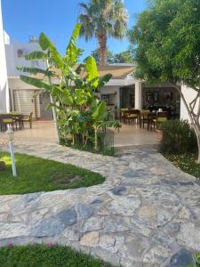 a stone walkway in front of a house at Canna Garden Hotel - Adult Only in Gümbet