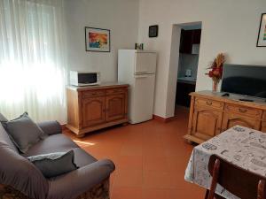 a living room with a couch and a refrigerator at APARTMENT ELI in Pag