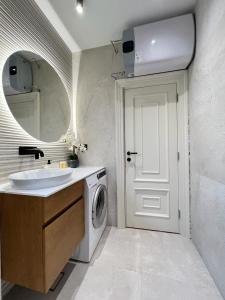 a bathroom with a sink and a washing machine at Vista Petrovac in Petrovac na Moru +19 photos