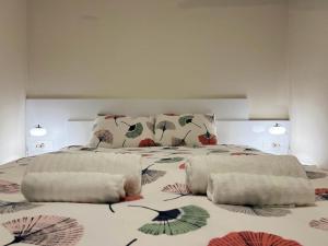 a bedroom with a large bed with pillows on it at Vista Petrovac in Petrovac na Moru