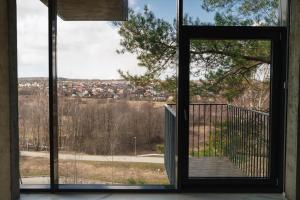 an open door to a balcony with a view at Exclusive Jacuzzi Apartaments Klaipėda in Aukštkiemiai