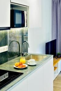 a kitchen with a sink and a plate of food at Myflats Luxury Old Town in Alicante