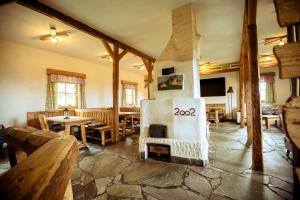 a living room with a fireplace and wooden furniture at Gamsberg Hütte in Pack