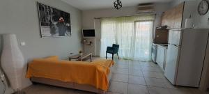 a living room with a couch and a refrigerator at Dimos Sunny & Luxury Central House !!! in Perea