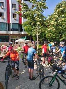 a group of people on bikes on a street at Hotel Piazza in Peshkopi