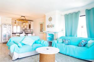 a living room with a blue couch and a table at La Golondrina - Beach froont in Corralejo