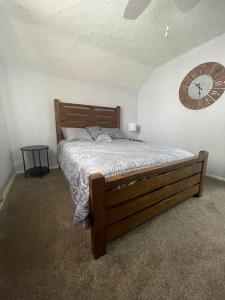 a bedroom with a bed and a clock on the wall at Comfortable 2 Bedroom Home in Historic Hibbing in Hibbing