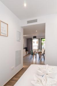 a living room and dining room with a table and chairs at Myflats Luxury Old Town in Alicante