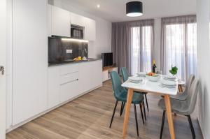 a kitchen and dining room with a table and chairs at Myflats Luxury Old Town in Alicante