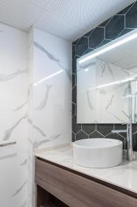 a bathroom with a sink and a mirror at Myflats Luxury Old Town in Alicante