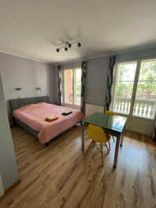 a bedroom with a bed and a glass table at Edgari Guesthouse in Otepää