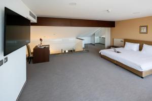 Voodi või voodid majutusasutuse Uva Nestum Wine & SPA toas
