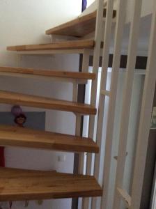 a set of wooden stairs in a room at Dachstudio mit Bad und Terasse in Cologne