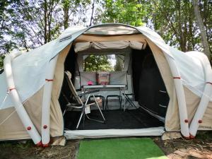 a tent with a table inside of it at La Finca - Campamento en la Naturaleza in Carranceja