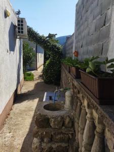 an alley with a sink in a stone wall at Sea Cottage Studios in Budva
