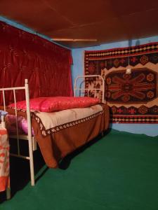 a bedroom with two bunk beds and a rug at Ecomama in Xınalıq Khinalig guest house in Quba