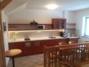a kitchen with a sink and a counter with a microwave at apartmány Zak in Frymburk +14 photos