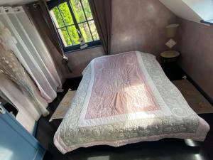 a small bedroom with a bed in the attic at Bienvenue à Soledad notre havre de paix in Étaples