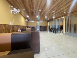 a lobby with a desk and chairs in a building at BLD Restaurant And Home Stay in Dehradun