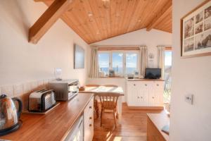 a kitchen with a counter top with a microwave at St Anton in Lyme Regis