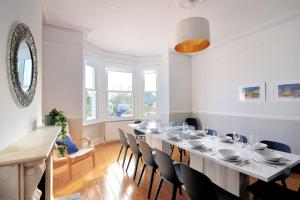 a large dining room with a long table and chairs at 7 Seafield Road in Seaton