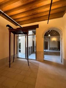 an empty room with a wooden ceiling and an archway at Immobiliare Nk Palazzo Bonvicini in Venice