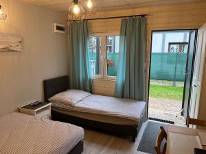 a small room with two beds and a window at Morena in Jarosławiec