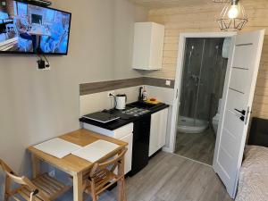 a small kitchen with a small table and a stove at Morena in Jarosławiec
