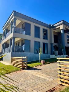 a large house with a driveway in front of it at Tuscany Hill Manor in Hartswater