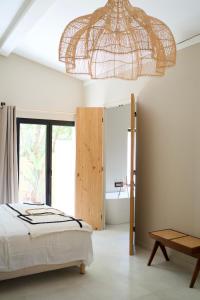 a bedroom with a bed and a chandelier at l'Amarantine in La Ciotat +55 photos
