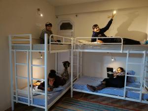 a group of people on bunk beds in a room at Hotel Kasauli Regency Stags Not Allowed in Kasauli