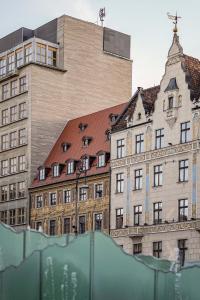a large building in front of a building at Great Polonia The Granary La Suite Hotel in Wrocław