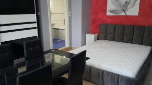 a bedroom with a bed and a glass table at HOPE HOUSE in Kavála