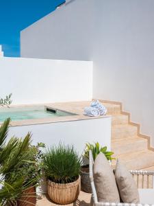a patio with plants and a swimming pool at The Standard, Ibiza in Ibiza Town