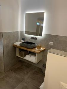 a bathroom with a sink and a mirror at Albergo Ristorante Montebaldo in Limone sul Garda