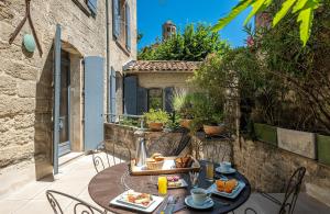 a table with food on it on a patio at Boutique Hôtel Entraigues in Uzès
