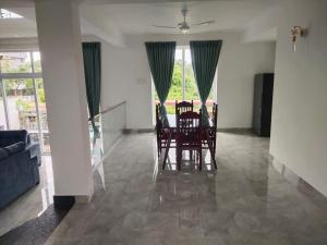 a dining room with a table and chairs in a room at Mer Vue Villa, Kovalam, ECR, Chennai in Chennai