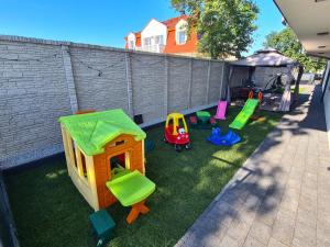 a backyard with some play equipment on the grass at BALTIC RESIDENCE in Łeba