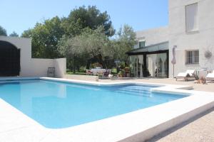 a swimming pool in front of a house at 032 Villa Albardanera in Pedreguer