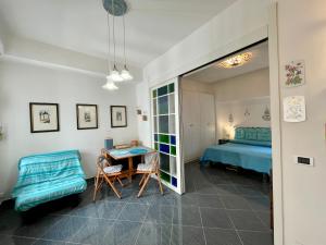 a bedroom with a bed and a table and chairs at LA CASETTA NEL BORGO - San Felice Circeo in San Felice Circeo