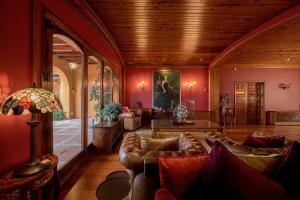 a living room with brown leather couches in a room at Rigat Park & Spa Hotel - Adults Recommended in Lloret de Mar