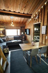 a living room with a table and a couch at RukaTupasvilla in Ruka