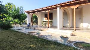 a home with a patio with potted plants in the yard at Dyada Home in Nea Stira