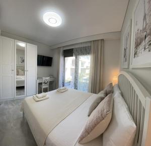a bedroom with a large bed and a window at CALLISTO Luxury Suite in Nikiti +27 photos