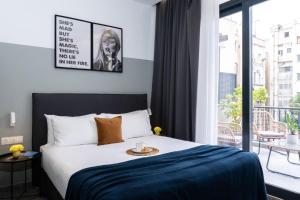 a hotel room with a bed and a balcony at PAME Paradiso in Athens